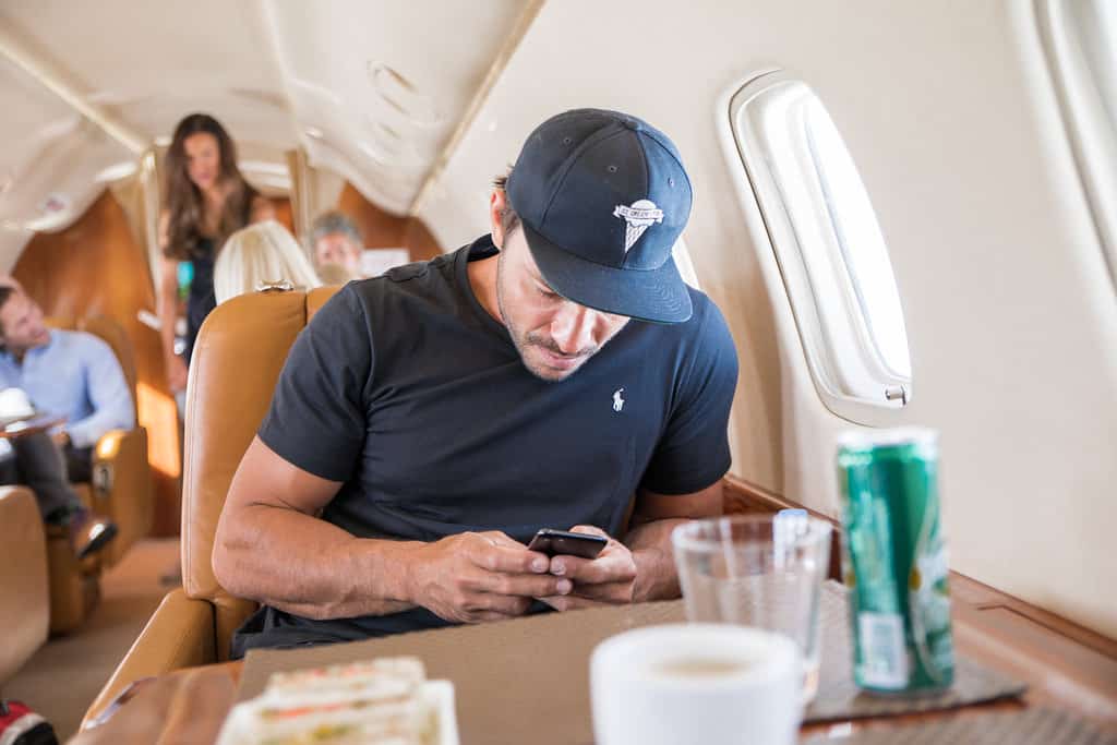 A guy on a private jet texting