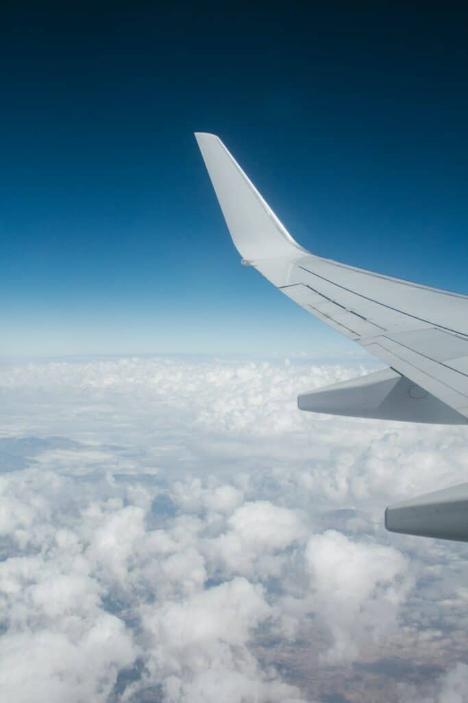 Airplane wing above clouds