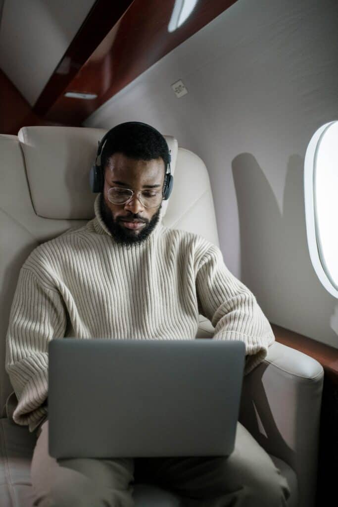 man on laptop in private jet