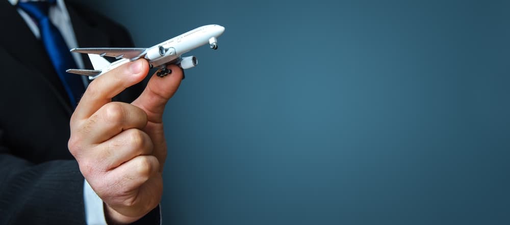 Businessman holding an airplane